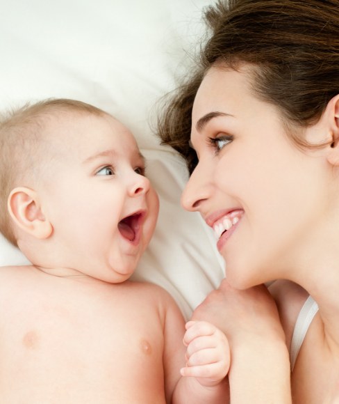 Mother and baby laughing together