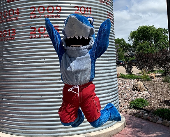 Sammy the Shark mascot jumping in the air