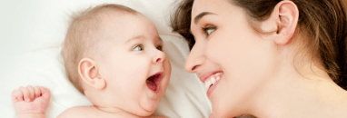 Mother smiling at baby after infant oral healthcare visit