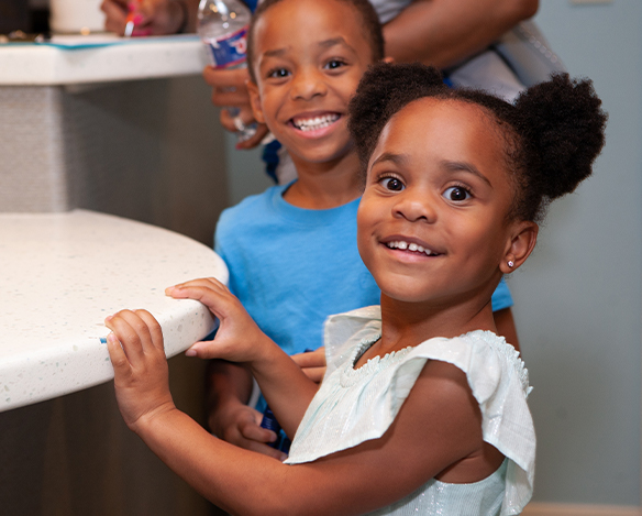 Two smiling children in dental office