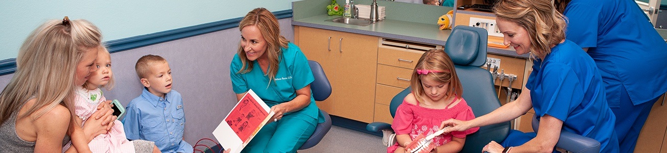 Two pediatric dental team members and Sammy the Shark