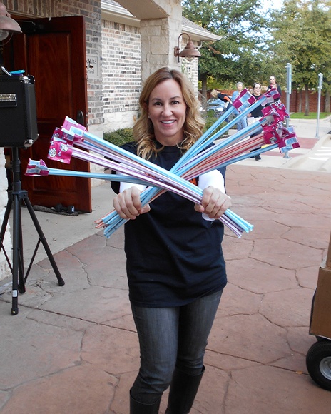 Dental team member holding up candy