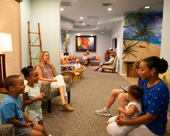 Parents and kids in dental office waiting room