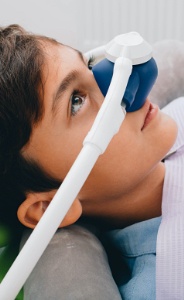 Young boy with nitrous oxide sedation dentistry mask