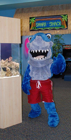 Shark Mascot next to fish tank