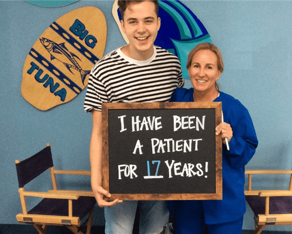 Doctor Rozas and teen patient smiling together