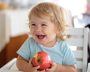 Young child eating healthy as recommended by Coppell pediatric dentist 