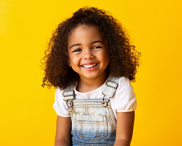 Little girl smiling after fluoride treatment