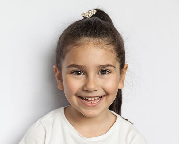 Little girl smiling during special needs dental appointment