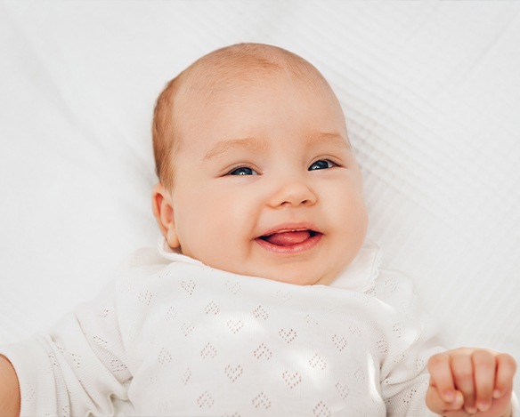 Child smiling after lip and tongue tie treatment