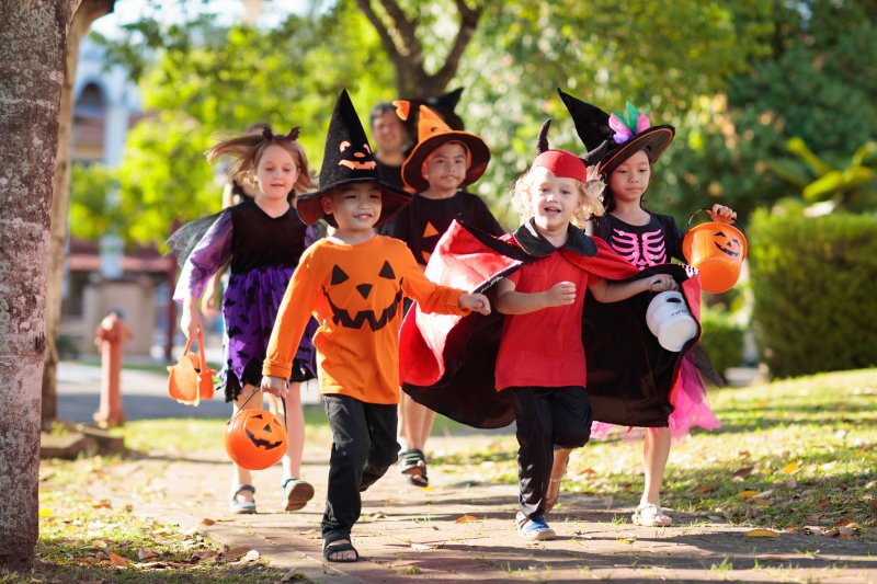 a group of young kids trick-or-treating on Halloween 