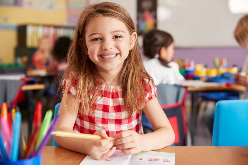 little girl happy about her time at school