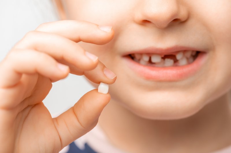 child with tooth that fell out