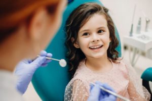 a child smiling while at the dentist